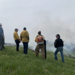 Group of people look into a cloud of smoke